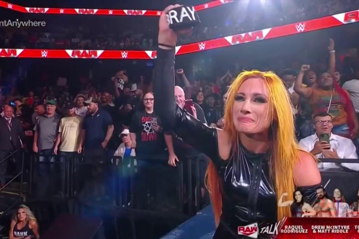Becky Lynch gets emotional while holding up her Bray Wyatt armband ❤️